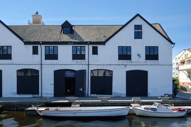 Small boats next to a white building